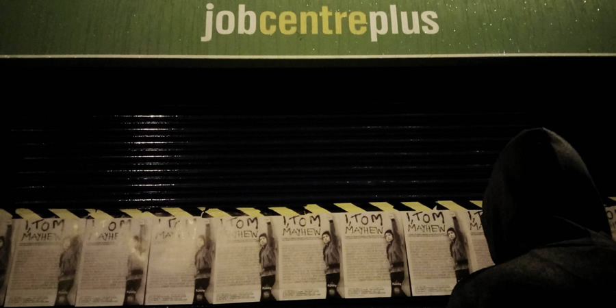Tom Mayhew putting flyers on the job centre. Tom Mayhew putting flyers on the job centre.